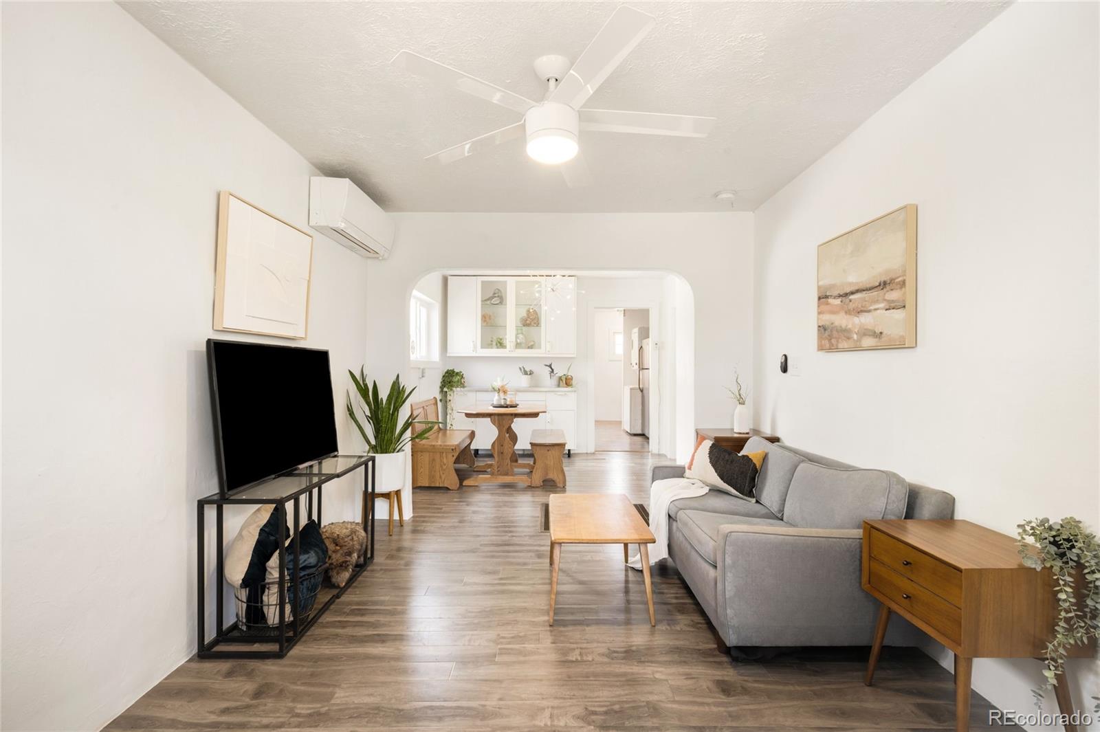 6800 Monaco Street Commerce City, CO 80022 - Photo 4 of 29 a living room with furniture and a flat screen tv