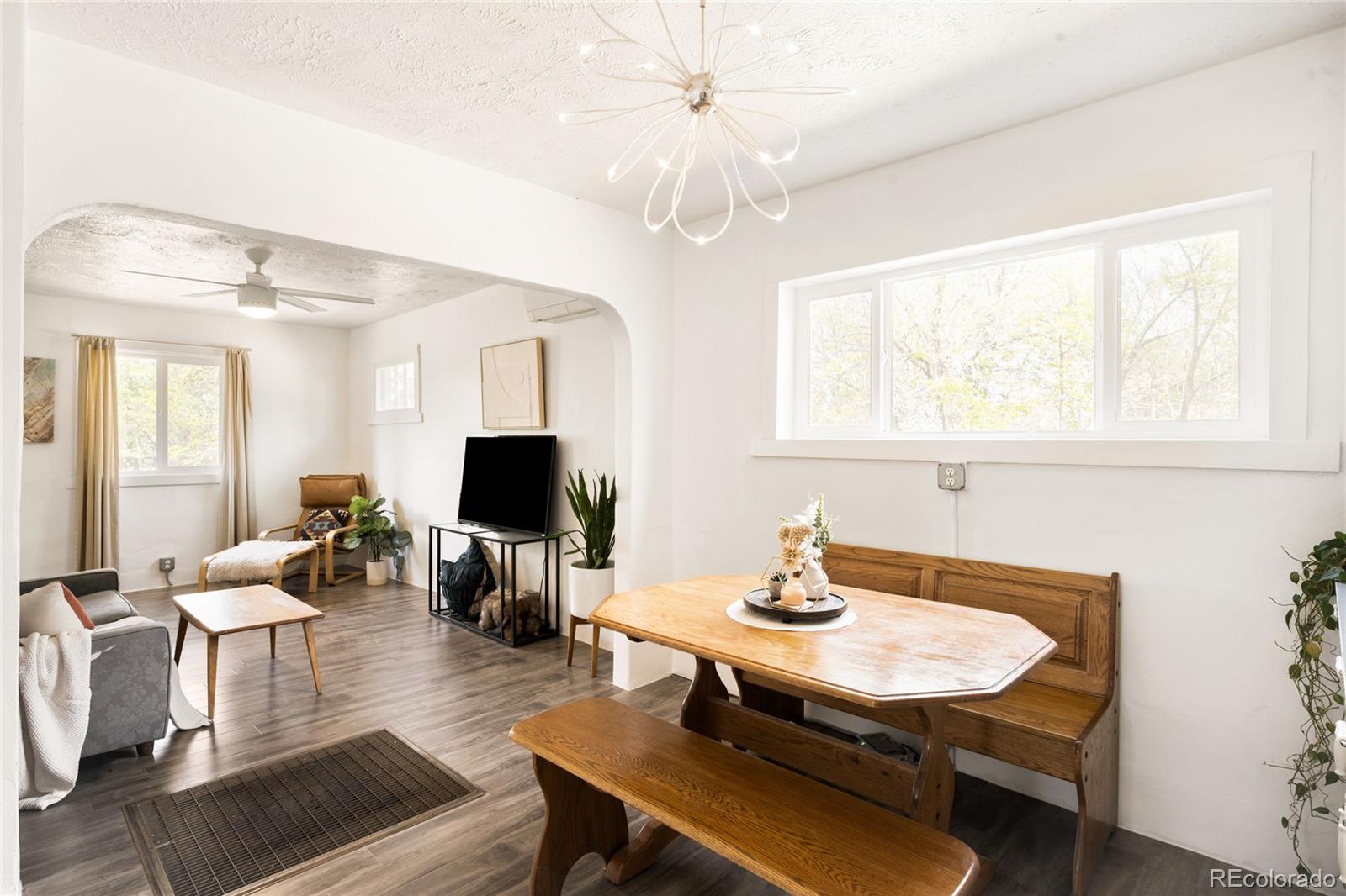 6800 Monaco Street Commerce City, CO 80022 - Photo 8 of 29 a living room with furniture a table and a large mirror