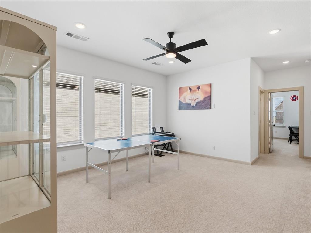 9533 Keep Street Frisco, TX 75035 - Photo 23 of 40 Spacious room featuring neutral carpet flooring, three large windows with blinds, a ceiling fan, and recessed lighting