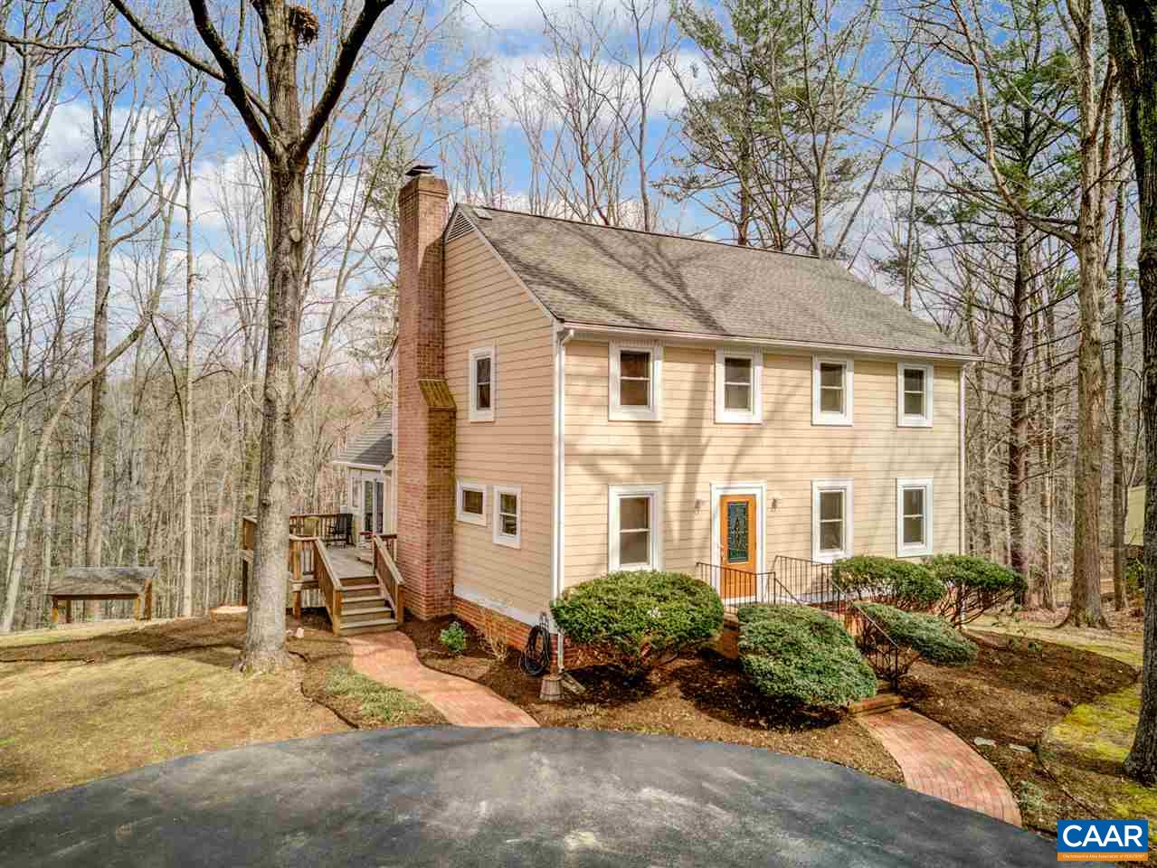 2295 Whippoorwill Road Charlottesville, VA 22901 - Photo 41 of 49 a view of a blue house with a large windows and a large tree