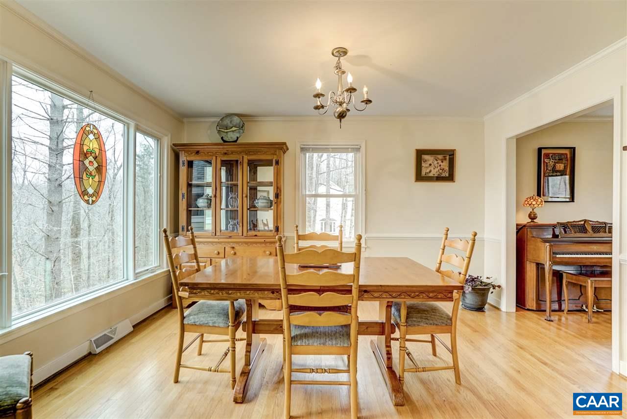 2295 Whippoorwill Road Charlottesville, VA 22901 - Photo 8 of 49 a view of a dining room with furniture a chandelier and wooden floor