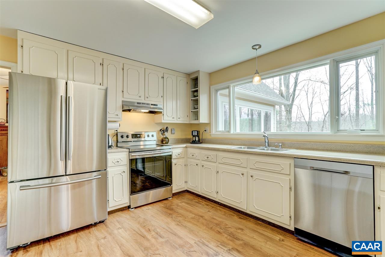 2295 Whippoorwill Road Charlottesville, VA 22901 - Photo 10 of 49 a kitchen with white cabinets and white appliances