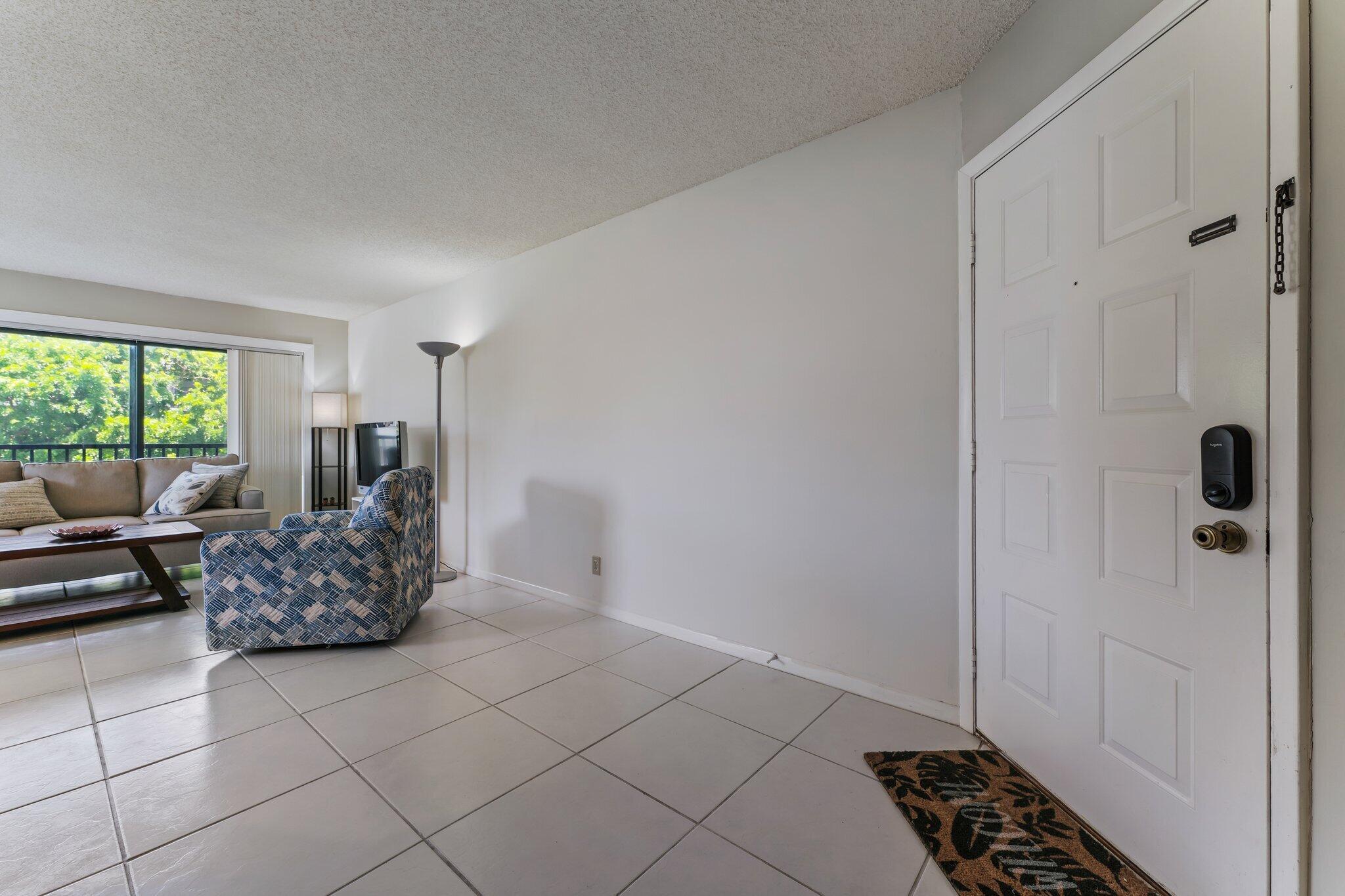 1605 Highway 1, Unit D301 Jupiter, FL 33477 - Photo 8 of 46 a living room with furniture and a window