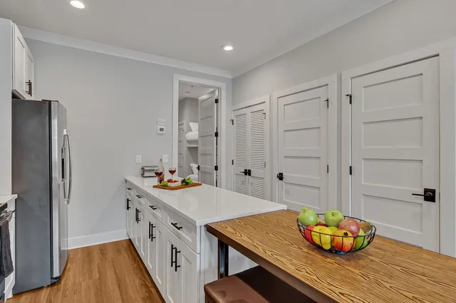 a kitchen with stainless steel appliances cabinets and wooden floor
