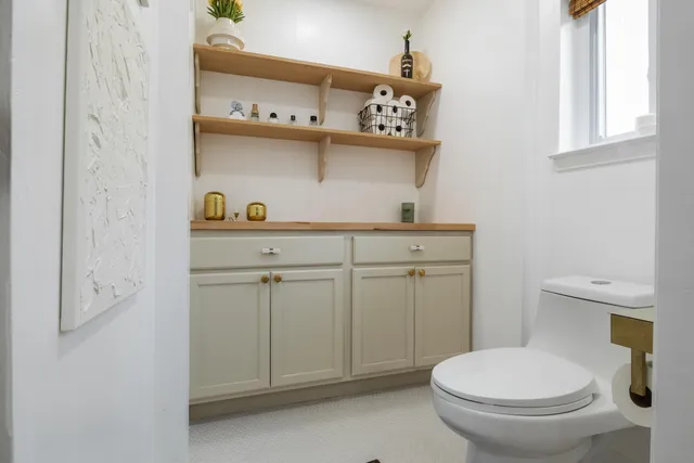 a living room with furniture and large windows