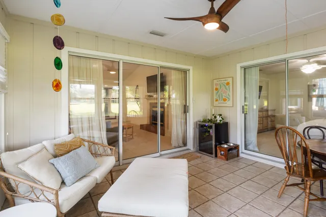 a view of a house with backyard and sitting area