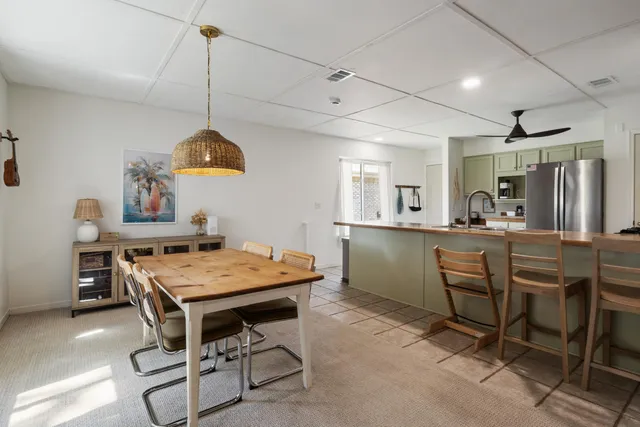 a dining room with a table and chairs