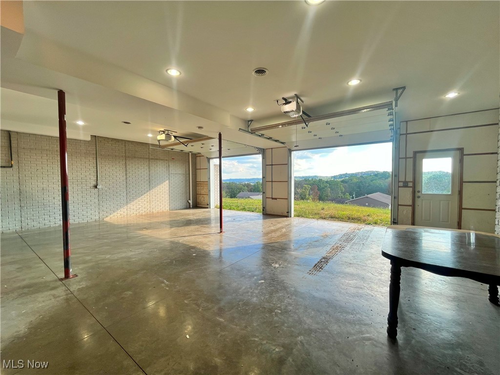 17583 Davis Ridge Road Caldwell, OH 43724 - Photo 39 of 42 Garage with recessed lighting and a garage door opener