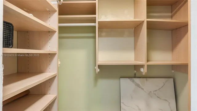 a bathroom with a sink toilet vanity and shower