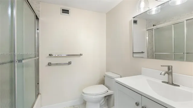 a bathroom with a glass shower door