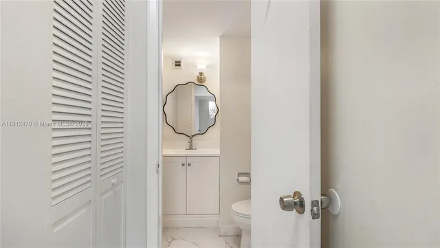 a bathroom with a mirror and a sink