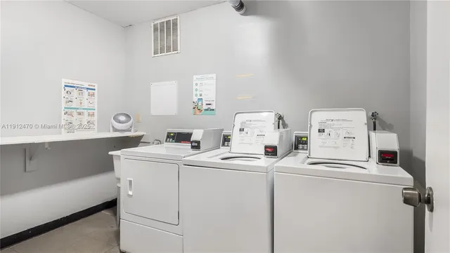 a large bedroom with a bed and wooden floor