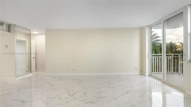 a view of a hallway with a chandelier fan and windows