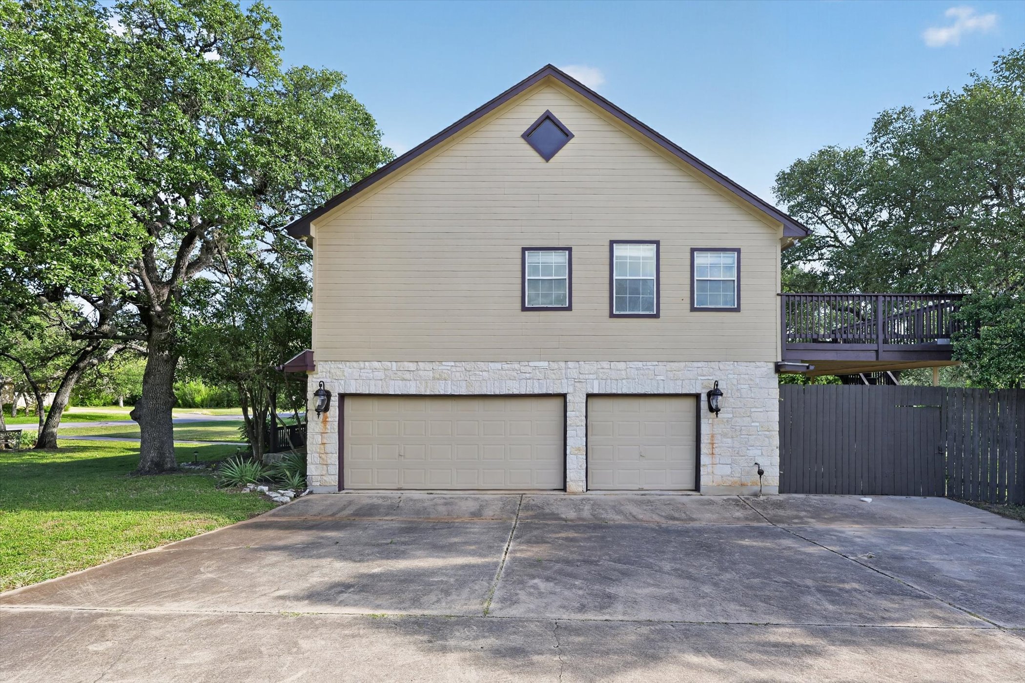 13615 Copperleaf Trail Manchaca, TX 78652 - Photo 38 of 38 A two-car garage with a spacious driveway offers convenience and ample parking.