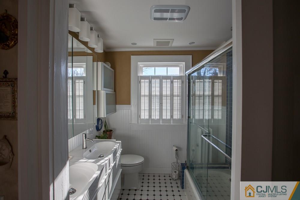 60 Rector Street Metuchen, NJ 08840 - Photo 12 of 25 a bathroom with a toilet sink and shower
