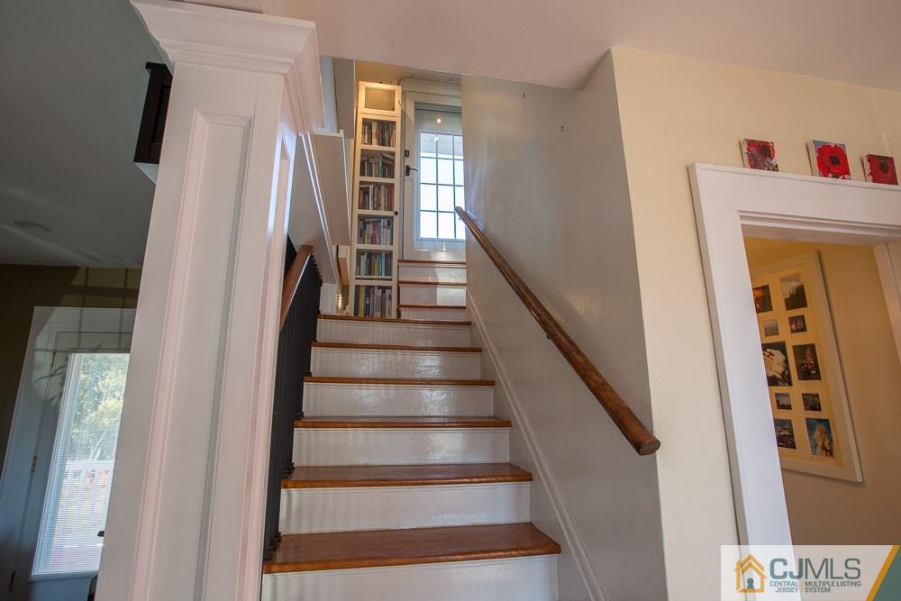 60 Rector Street Metuchen, NJ 08840 - Photo 14 of 25 a view of staircase with lots of frames on wall and a window