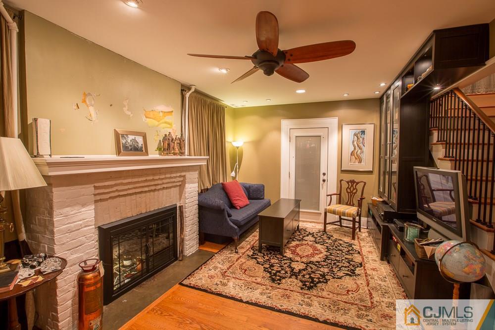 60 Rector Street Metuchen, NJ 08840 - Photo 22 of 25 a living room with furniture a flat screen tv and a fireplace