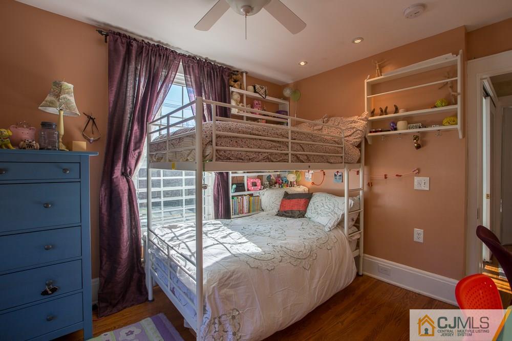 60 Rector Street Metuchen, NJ 08840 - Photo 10 of 25 a bedroom with a bed and a chandelier