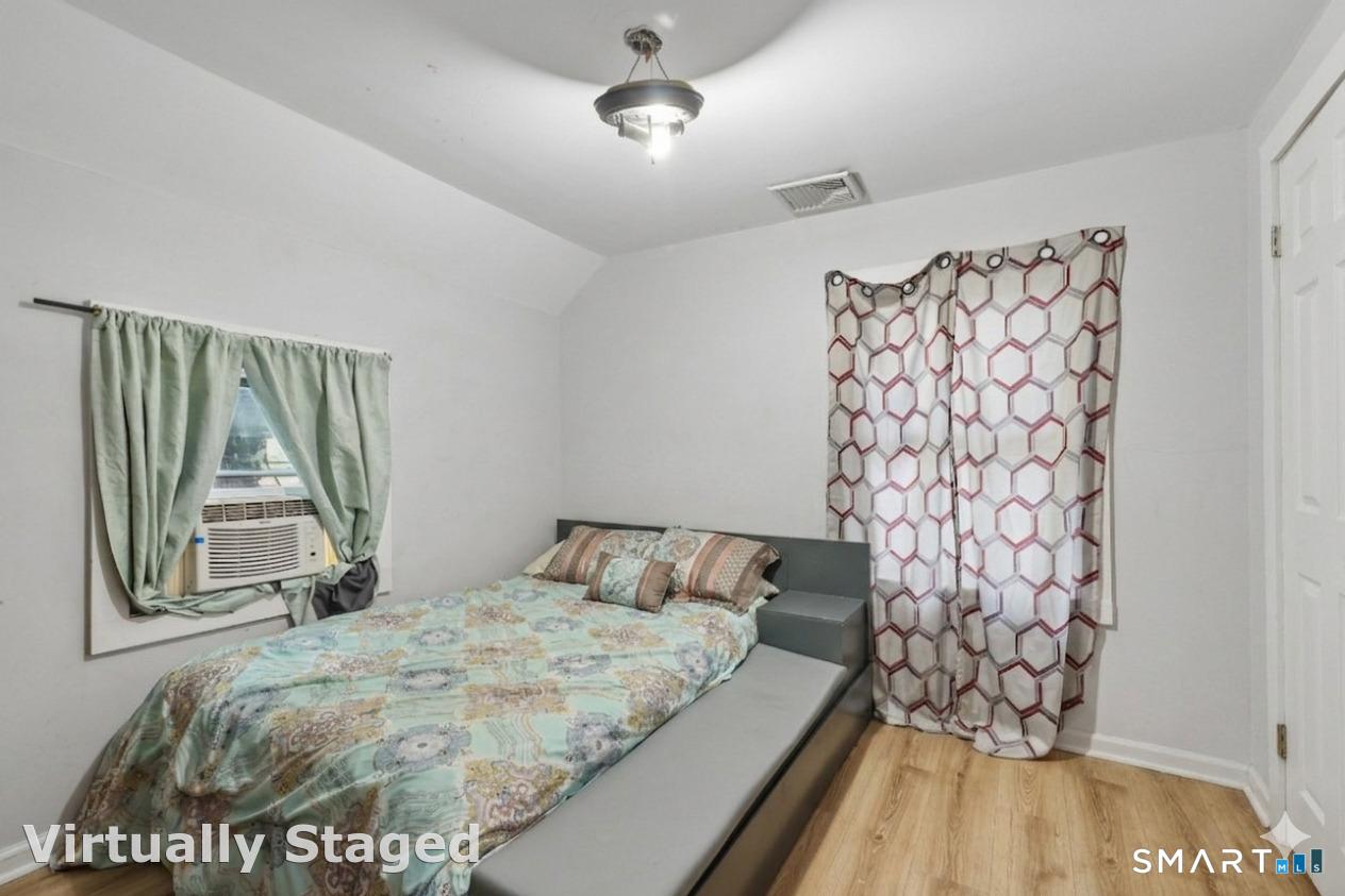 37 Manhan Street Waterbury, CT 06710 - Photo 12 of 19 a bedroom with a bed and a window