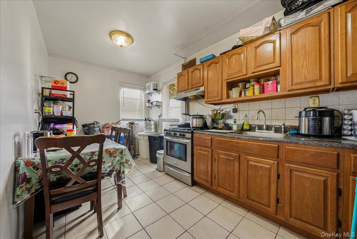 2304 Glebe Avenue Bronx, NY 10462 - Photo 19 of 36 a kitchen with stainless steel appliances granite countertop a stove and cabinets