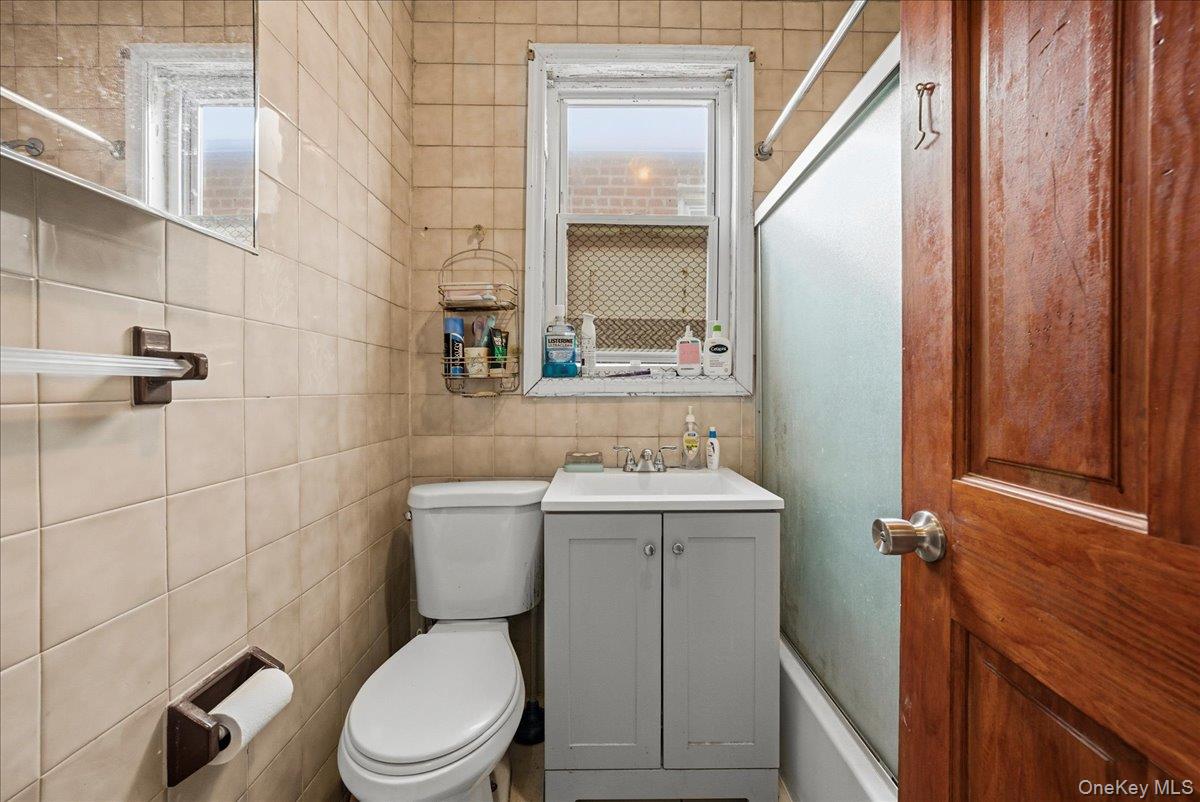 2304 Glebe Avenue Bronx, NY 10462 - Photo 21 of 36 a bathroom with a toilet a sink and a mirror