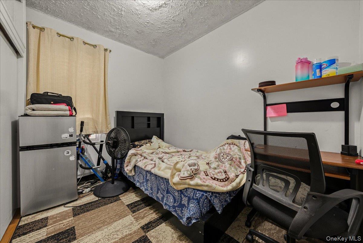 2304 Glebe Avenue Bronx, NY 10462 - Photo 24 of 36 a bedroom with a bed and a dresser