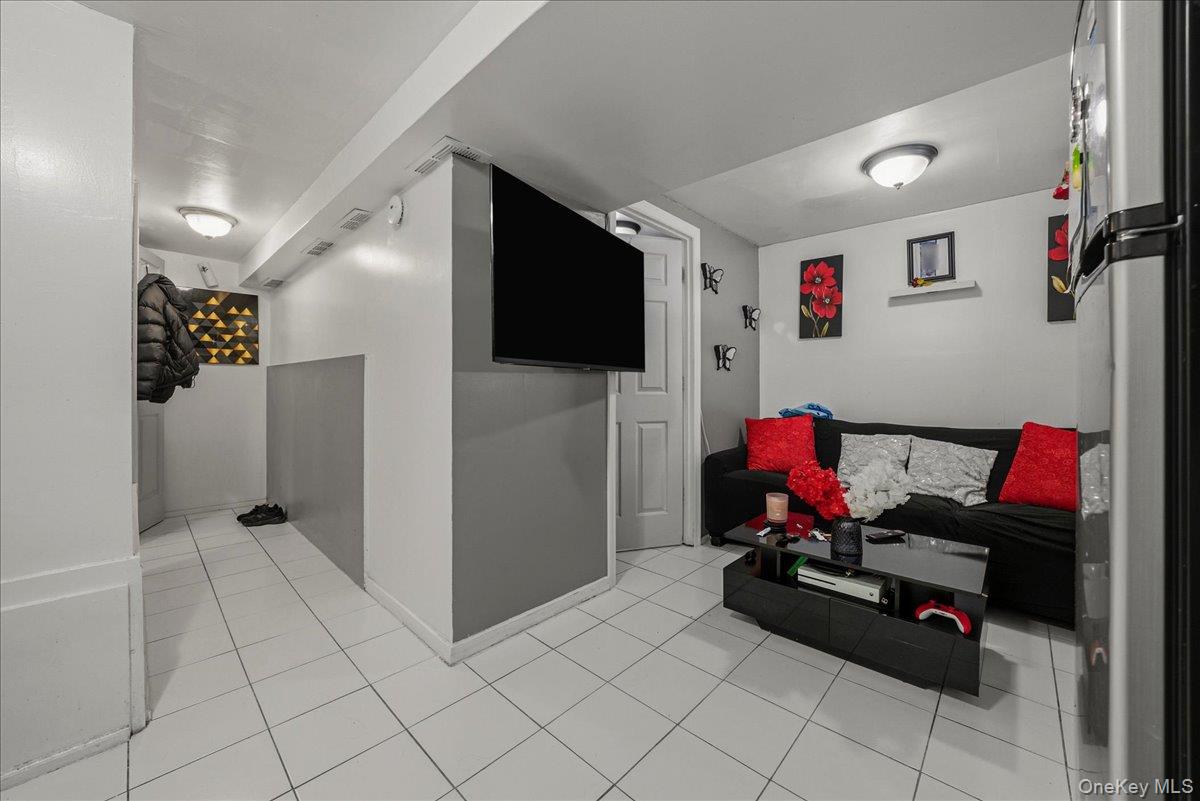 2304 Glebe Avenue Bronx, NY 10462 - Photo 27 of 36 a living room with furniture and a flat screen tv