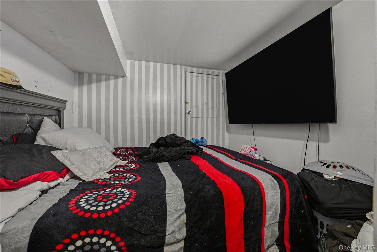 2304 Glebe Avenue Bronx, NY 10462 - Photo 29 of 36 a bedroom with a bed and flat screen tv