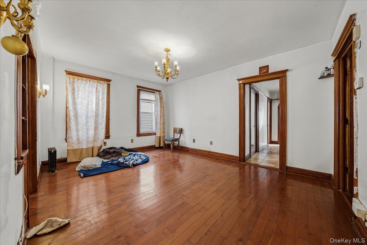 2304 Glebe Avenue Bronx, NY 10462 - Photo 5 of 36 a view of a livingroom with hardwood floor and a ceiling fan