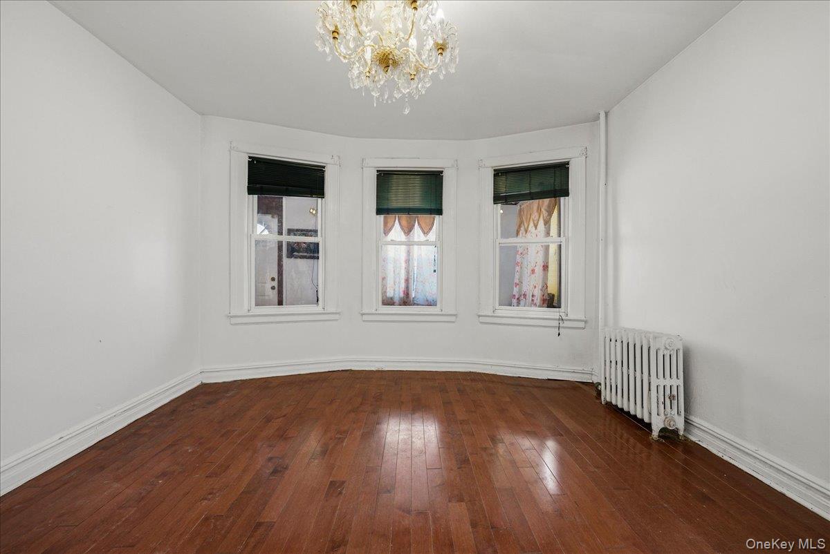 2304 Glebe Avenue Bronx, NY 10462 - Photo 7 of 36 a view of wooden floor and windows in a room