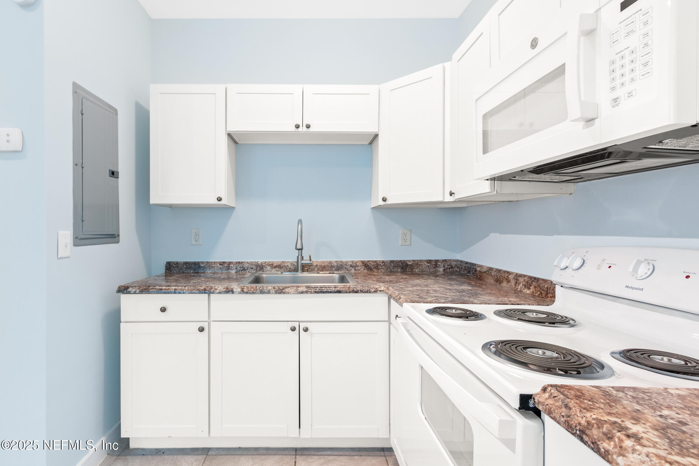 3039 Belden Street Jacksonville, FL 32207 - Photo 14 of 20 a kitchen with granite countertop a sink a stove and cabinets