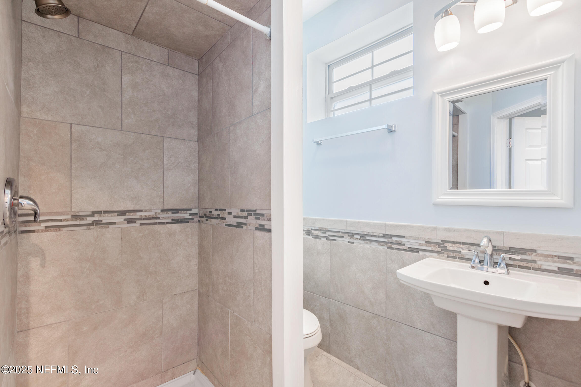 3039 Belden Street Jacksonville, FL 32207 - Photo 15 of 20 a bathroom with a sink a toilet and shower