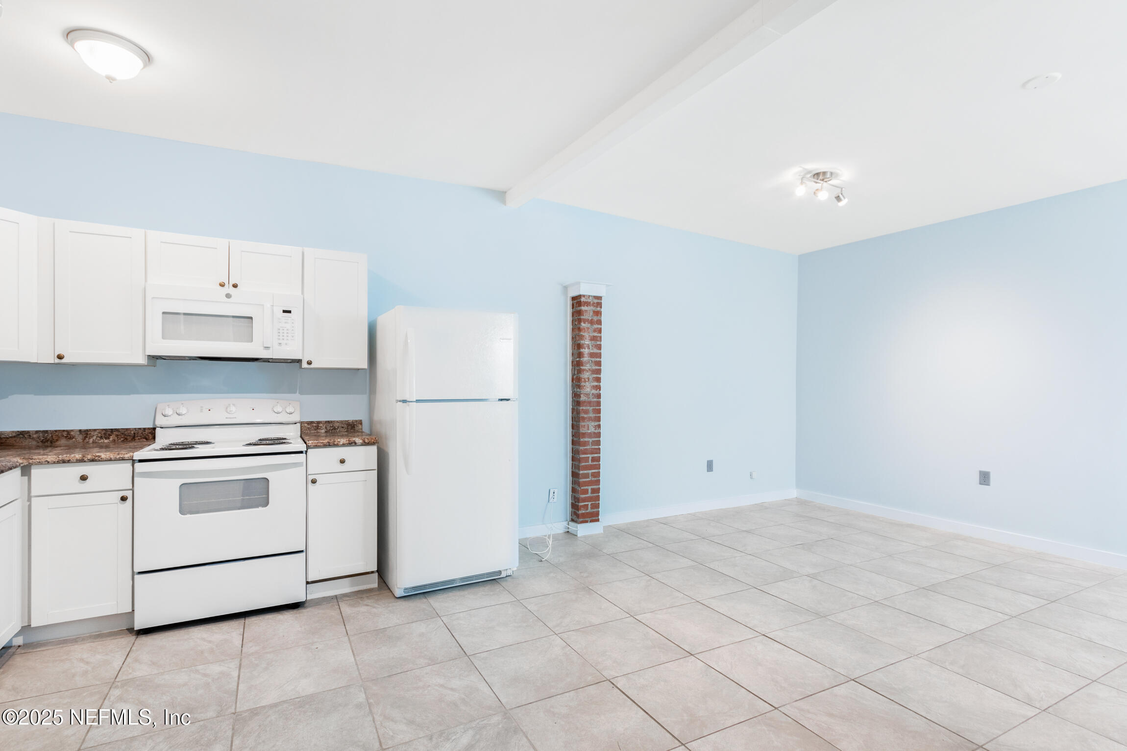 3039 Belden Street Jacksonville, FL 32207 - Photo 16 of 20 a kitchen with granite countertop white cabinets and white appliances