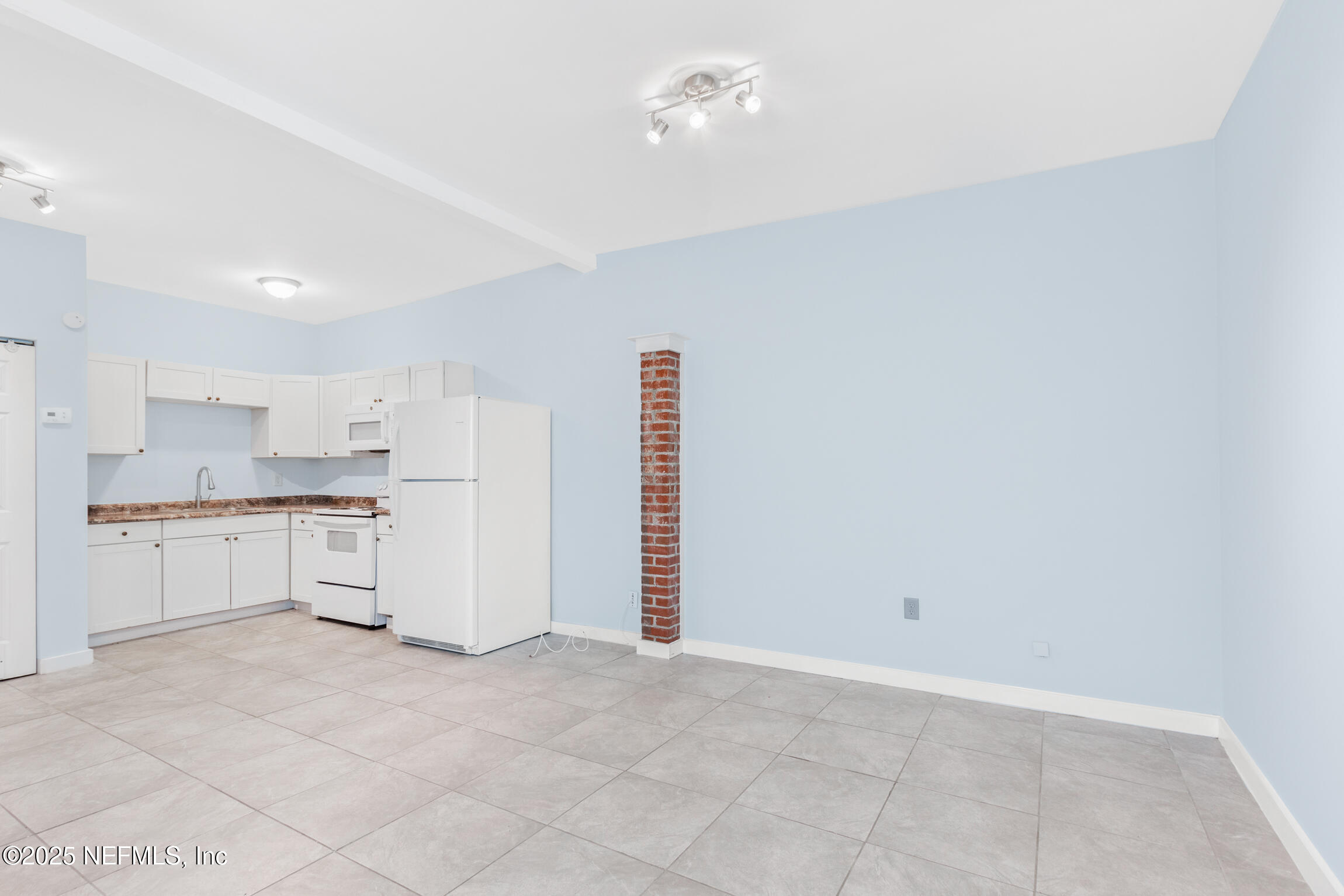 3039 Belden Street Jacksonville, FL 32207 - Photo 19 of 20 a kitchen with white cabinets and appliances