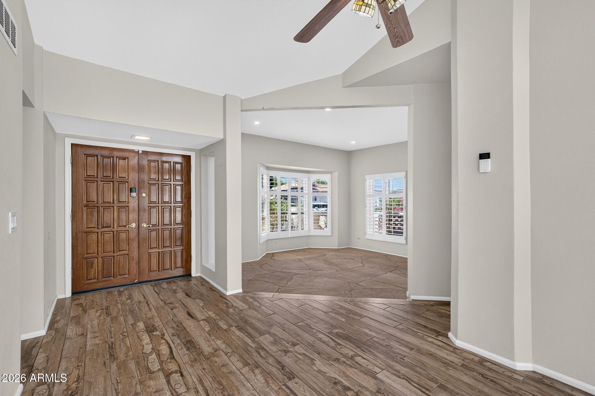 4615 East Monte Way Phoenix, AZ 85044 - Photo 27 of 35 an empty room with wooden floor cabinet and windows