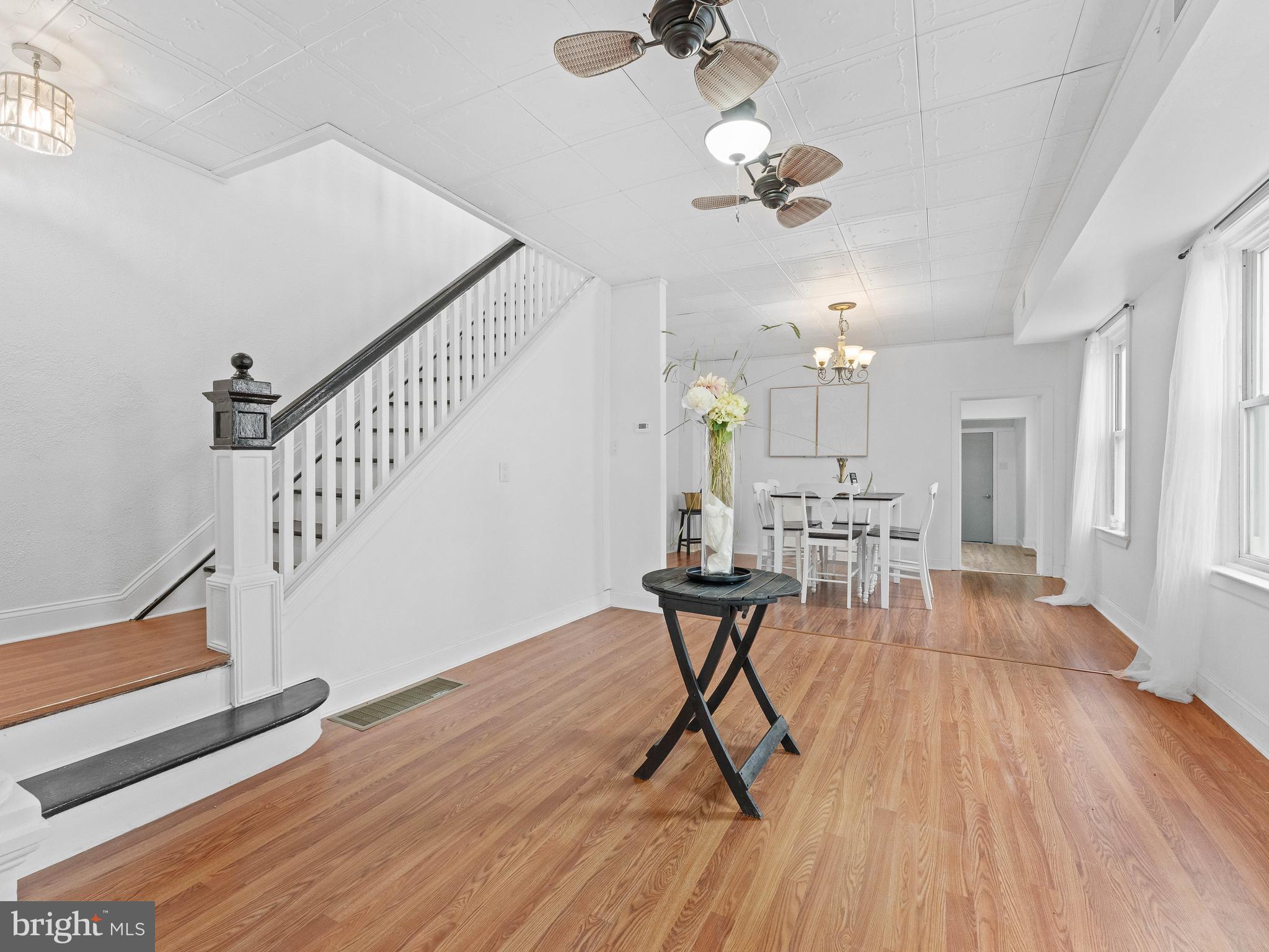 209 Upland Road Brookhaven, PA 19015 - Photo 9 of 39 a view of a livingroom with furniture wooden floor and chandelier