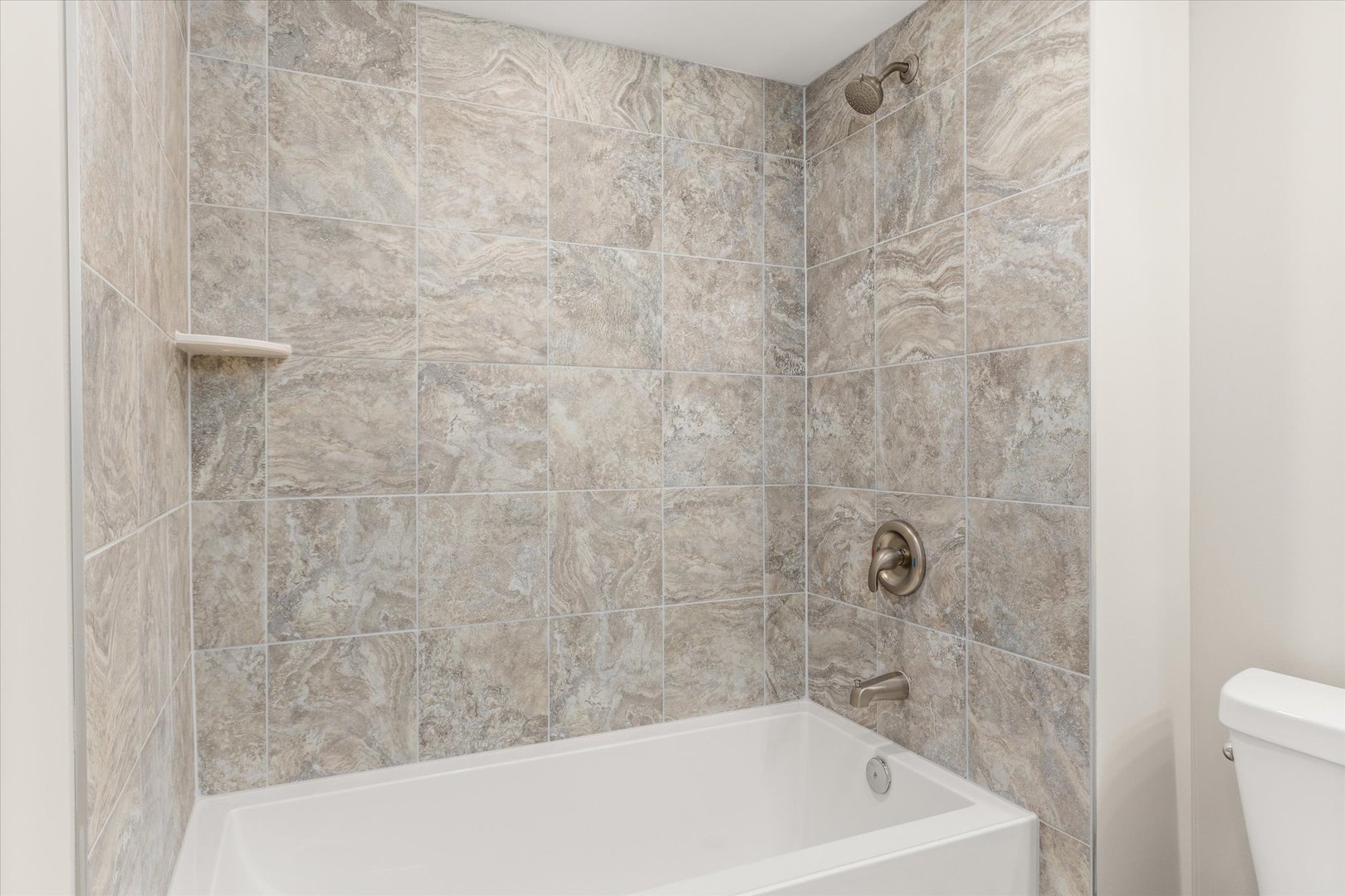 110 Kevin Drive Diamond, IL 60416 - Photo 31 of 39 a bath tub sitting next to a white toilet and a shower