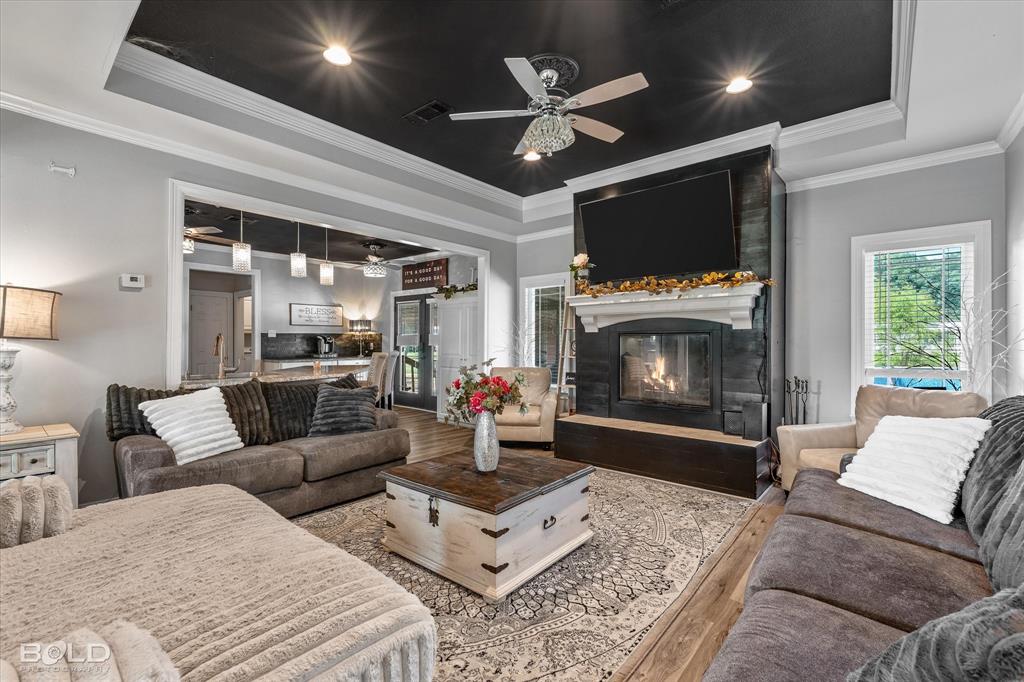 10606 Ferry Lake Road Oil City, LA 71061 - Photo 15 of 38 a living room with furniture a flat screen tv and a fireplace