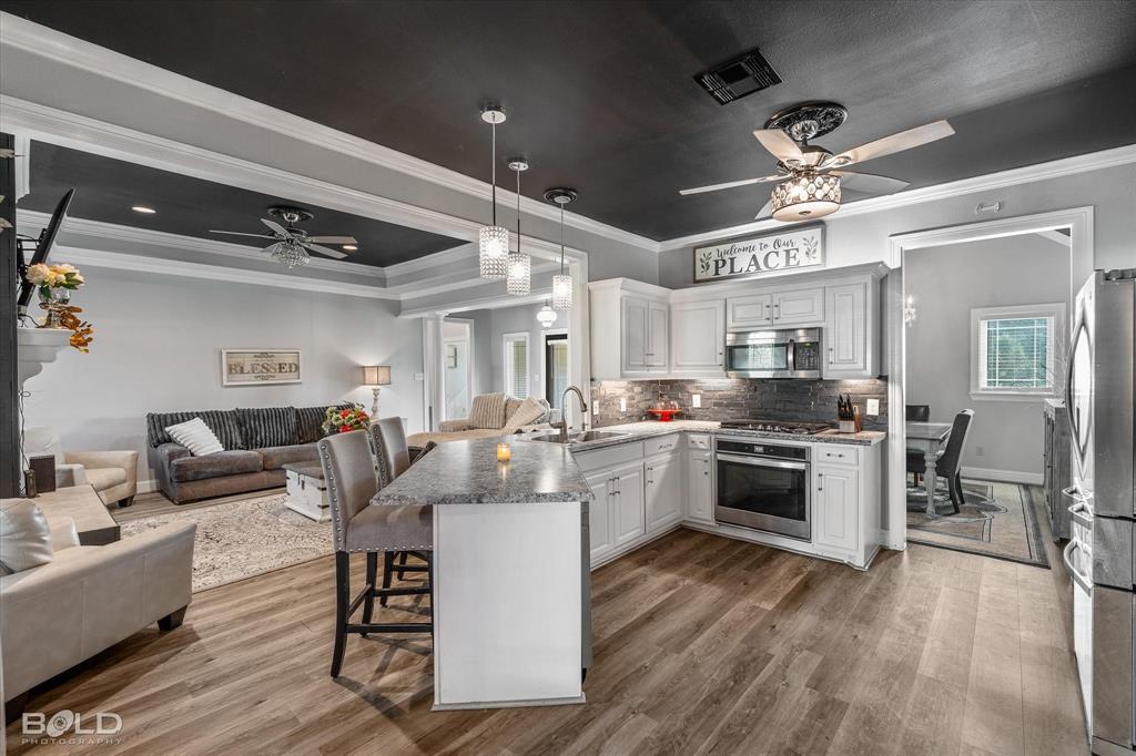10606 Ferry Lake Road Oil City, LA 71061 - Photo 18 of 38 a large white kitchen with lots of counter space a sink and appliances