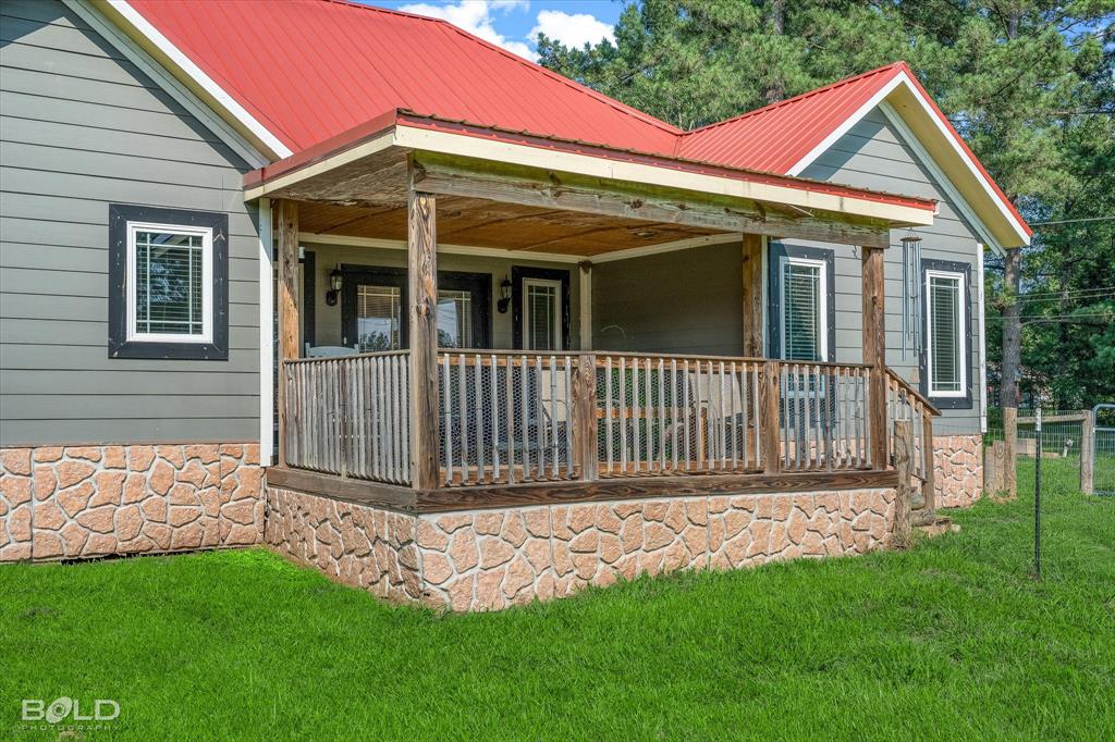10606 Ferry Lake Road Oil City, LA 71061 - Photo 5 of 38 a front view of a house with a garden
