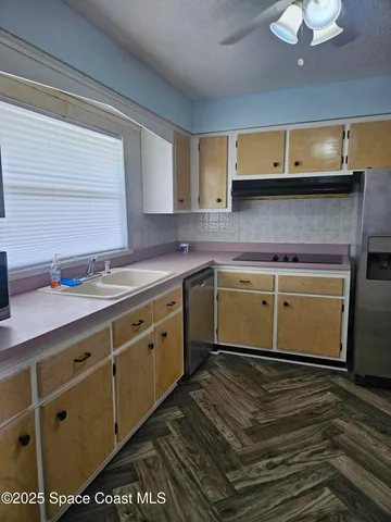 a kitchen with a sink and cabinets