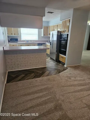 a view of a kitchen with a sink
