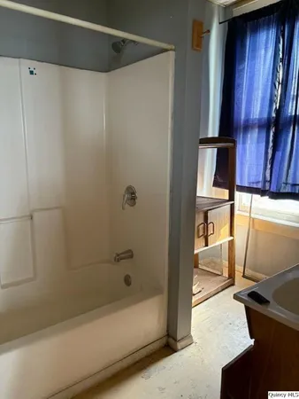 a bathroom with a bathtub and a shower