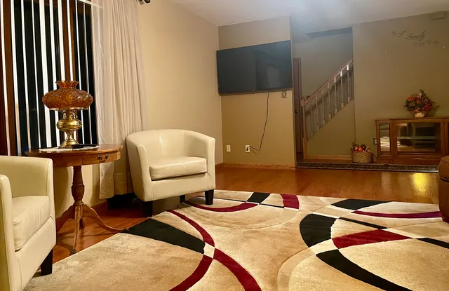 a kitchen with granite countertop a sink cabinets and wooden floor