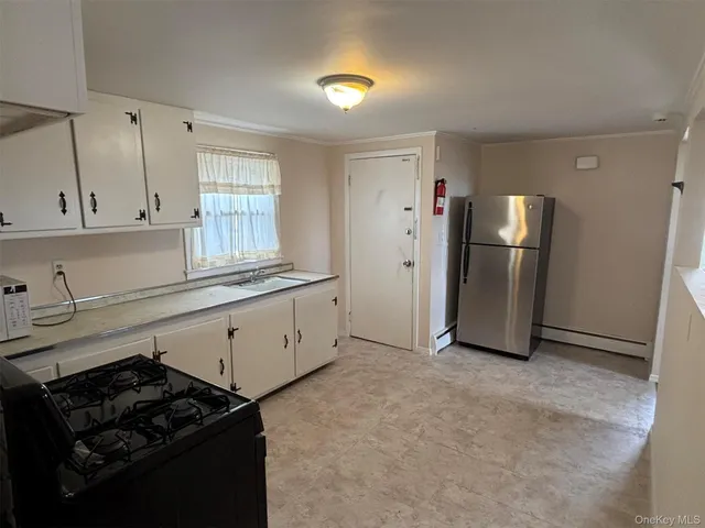 a kitchen with a refrigerator stove and cabinets