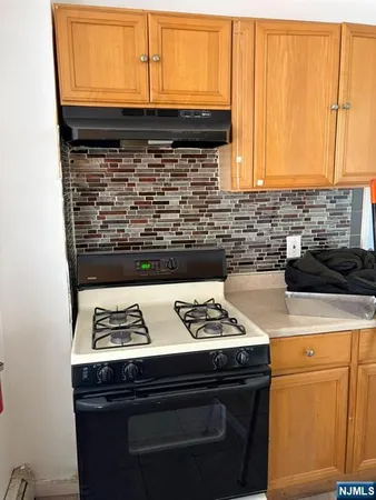 a kitchen with a stove and a cabinet