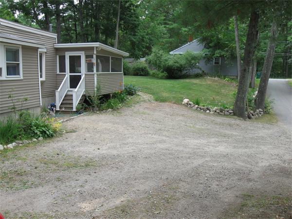 10 Cedar Road Groton, MA 01450 - Photo 3 of 27 a front view of a house with a yard