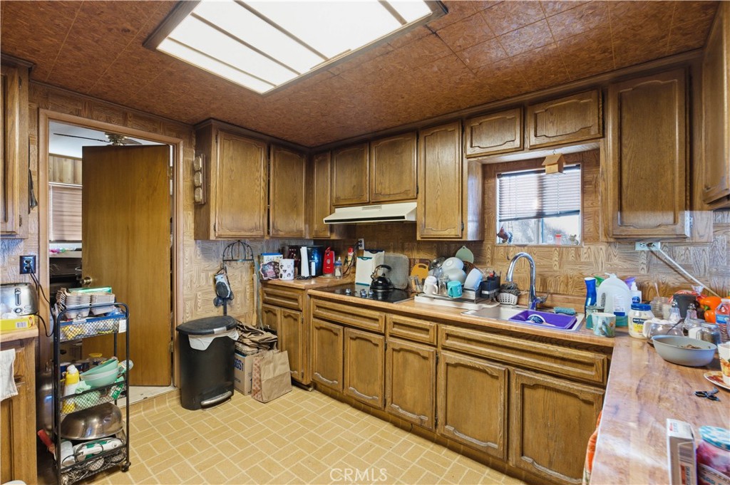 32787 Jagadon Road Lucerne Valley, CA 92356 - Photo 11 of 32 a kitchen with lots of counter top space and furniture