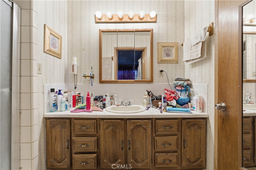 32787 Jagadon Road Lucerne Valley, CA 92356 - Photo 14 of 32 a bathroom with a sink vanity and a mirror