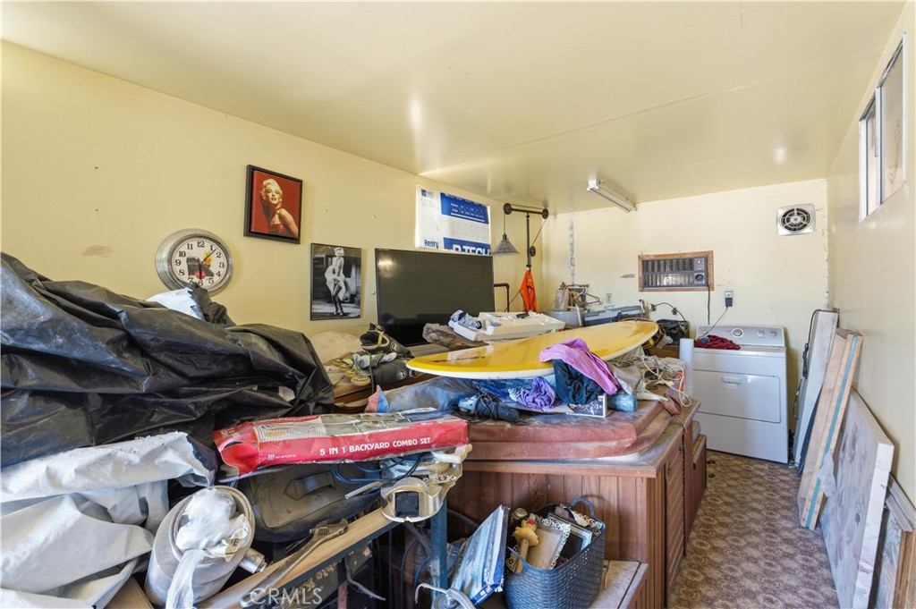 32787 Jagadon Road Lucerne Valley, CA 92356 - Photo 22 of 32 a living room with furniture a flat screen tv and a table